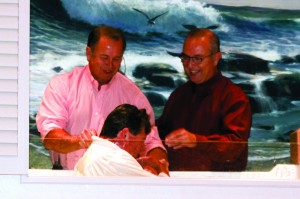 Gary Caldwell, pastor of Piedmont, First, left, joined Wendell Lang, pastor of Yukon, Surrey Hills, right, in baptizing Bill Turner, center.