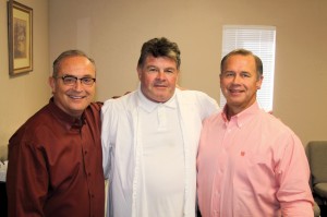 Turner, center, made a profession of faith after the prayer and influence of the two churches pastored by Lang, left, and Caldwell, right.