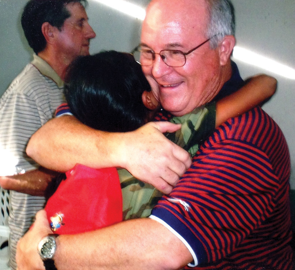 Merideth gets a hug while serving on a mission trip in Guatemala.