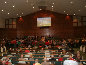 The Hispanic congregation spreads across the front of the Exchange Avenue auditorium as Exchange Avenue members pledge their support to the new church.
