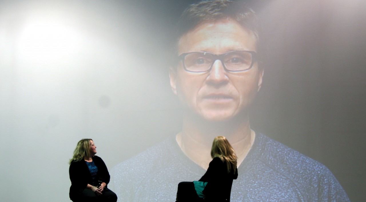 Oklahoma City Thunder head coach Scott Brooks surprises Lorelei Decker with encouraging words before she presents her story with her mom Andrea. 
