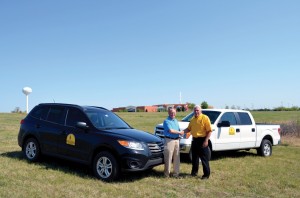 Moore, First Pastor Kevin Clarkson and BGCO Disaster Relief Director Sam Porter meet at the future site of the DR facility, with the church shown in the distant background.