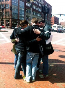 Members of the mission team prays with a Boston resident in the city. Prestonwood’s Young Singles ministry had been sending teams to help Boston church planters for more than a decade.
