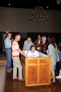 Justin Jester, pastor of Oklahoma City, Gateway officiates Mrs. Hurley’s baptism with family and friends witnessing and supporting.