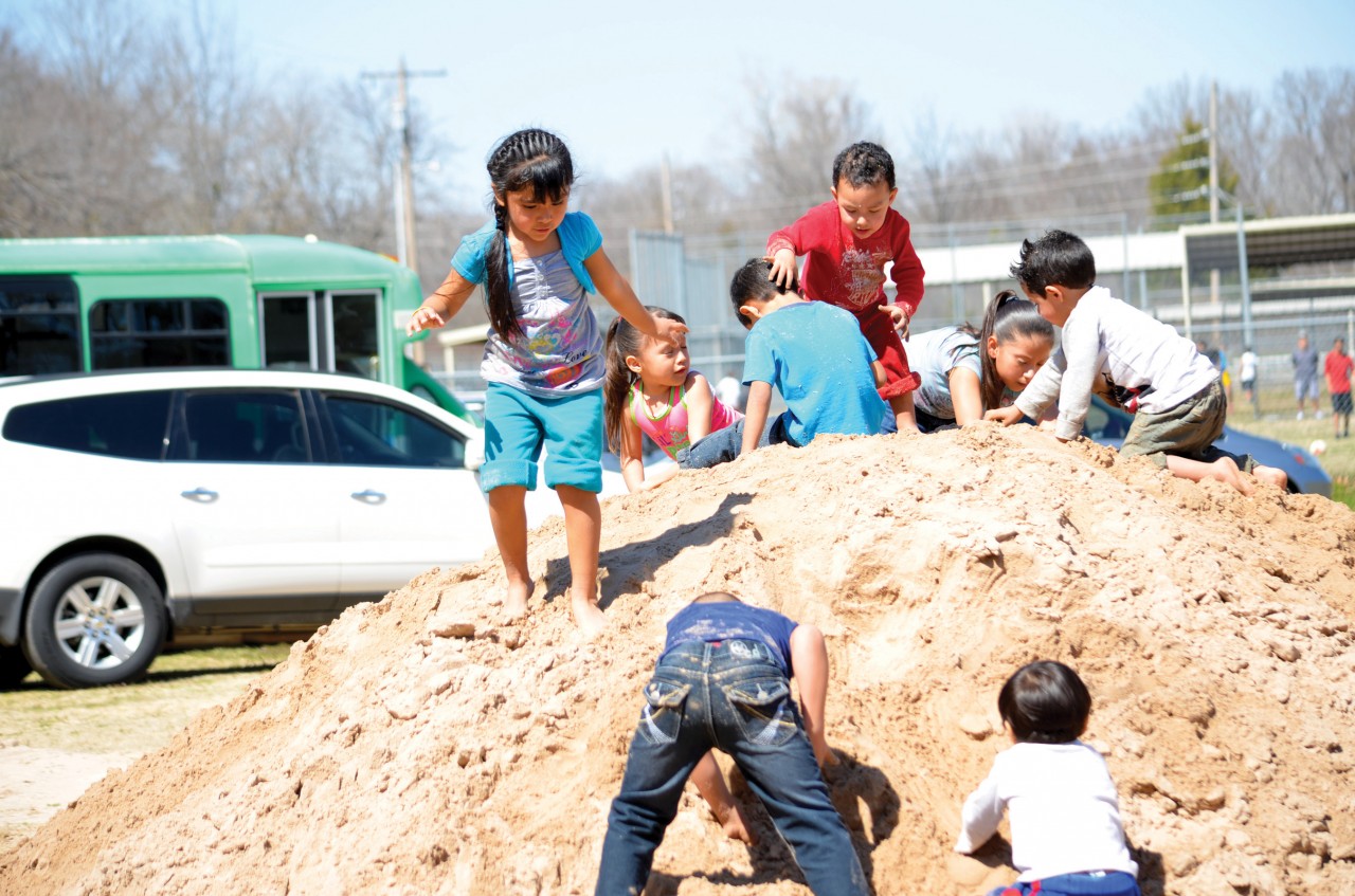 while older youths played organized sports, young children had just as much fun playing on a pile of dirt.