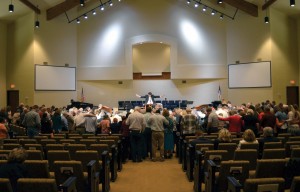 Pastor Keith Gillham leads the congregation in a prayer of dedication at the conclusion of the service. 2) The steeple of Hinton, First stretches into the sky, March 30 on dedication day.
