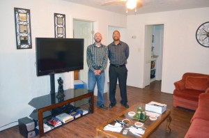 Assistant Director Jeff Elbert, left, and Senior Pastor Rick Gettens display the result of months of a labor of love by members of Lawton, Mind of Christ Multiethnic to repair one of the units of the Living Life: Housing with a Purpose program in the living room and kitchen of the first residence to house a participant in the program.