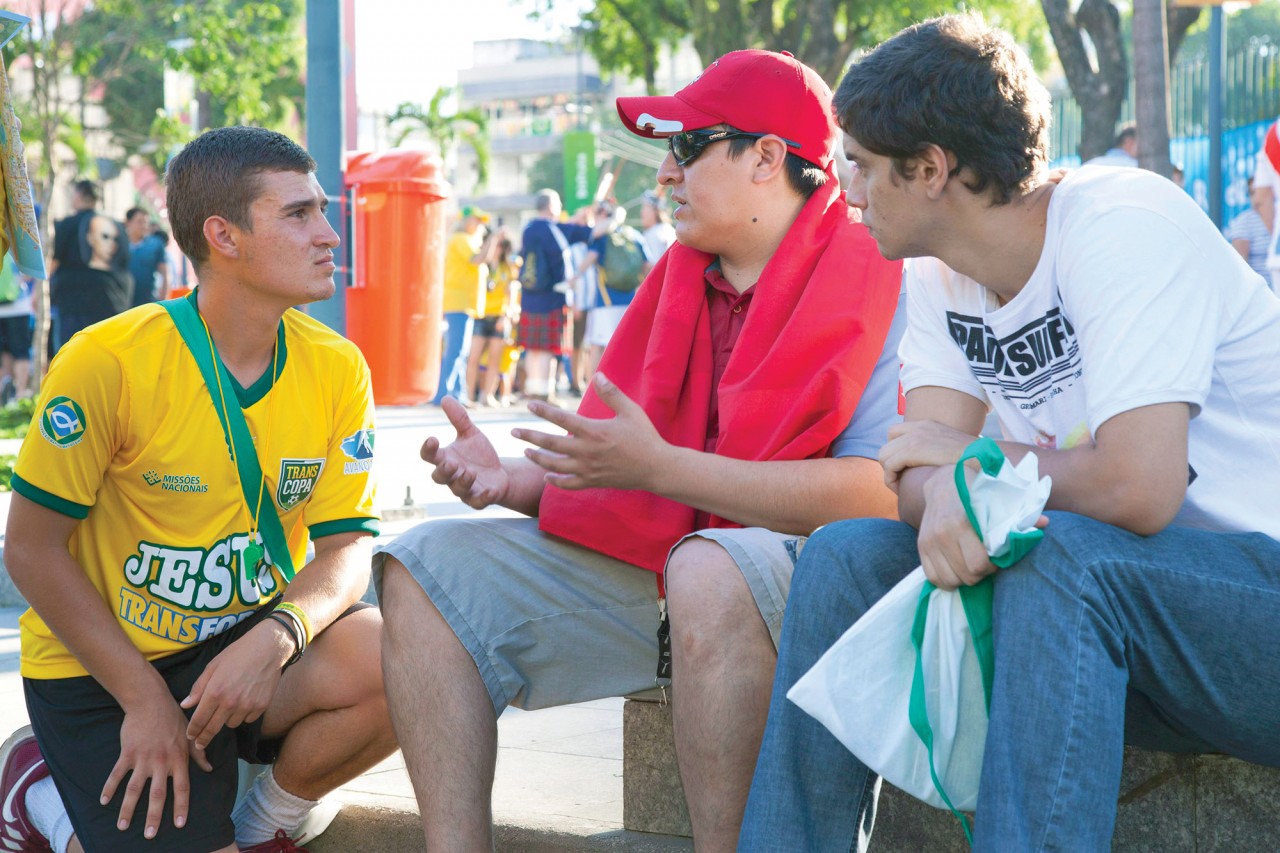 Nick Smirniotopoulos, a recent graduate of Virginia Tech, left, shares the Gospel with soccer fans outside Rio de Janeiro’s Maracana stadium.