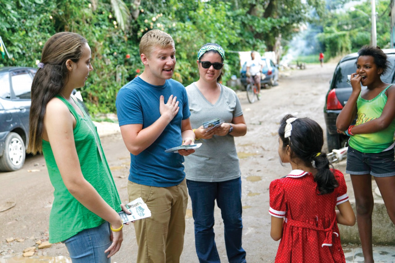 Dane Van Ryckeghem, center, and some teammates share the Gospel with Brazilians in a community on the outskirts of Rio de Janeiro.