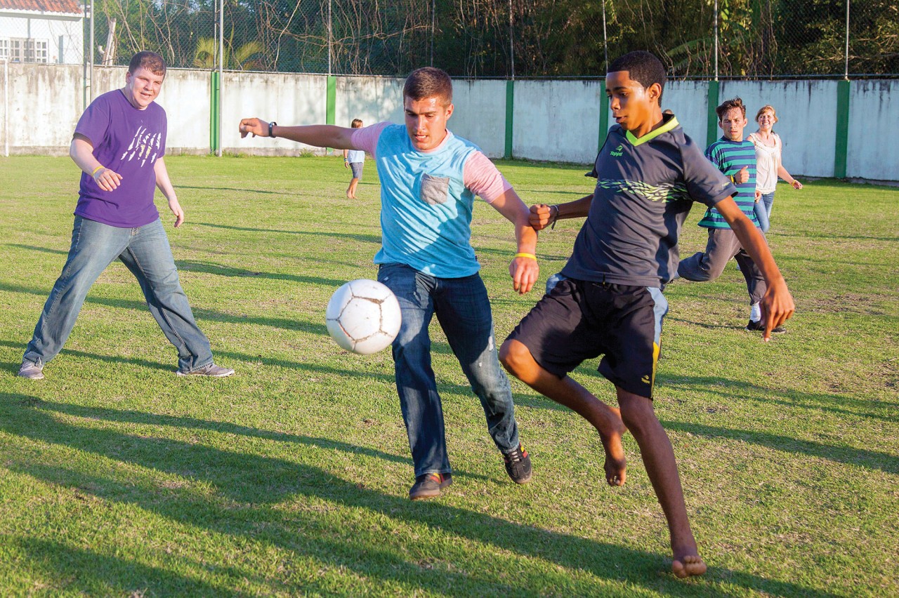Smirniotopoulos and some teammates enjoy a friendly game with Brazilian children.