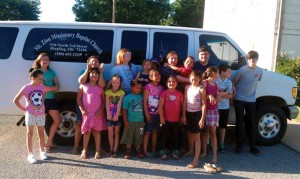 Jeffrey and Amy Willoughy, back row, gather children in front of the van recently donated to Michigan Ave. (Photo: Provided)