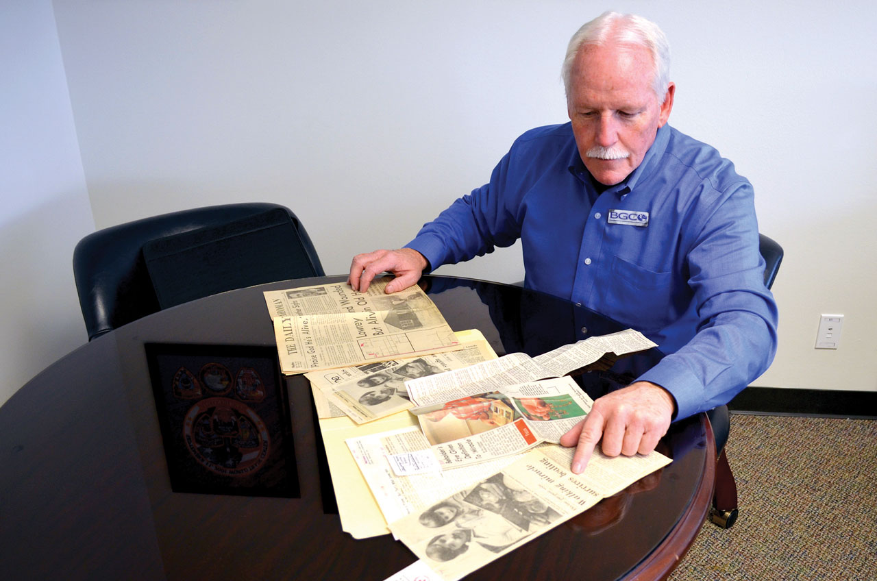 Lowrey looks through newspaper clippings about his ordeal 40 years ago from a file in the Baptist Messenger office. (Photo: Bob Nigh)