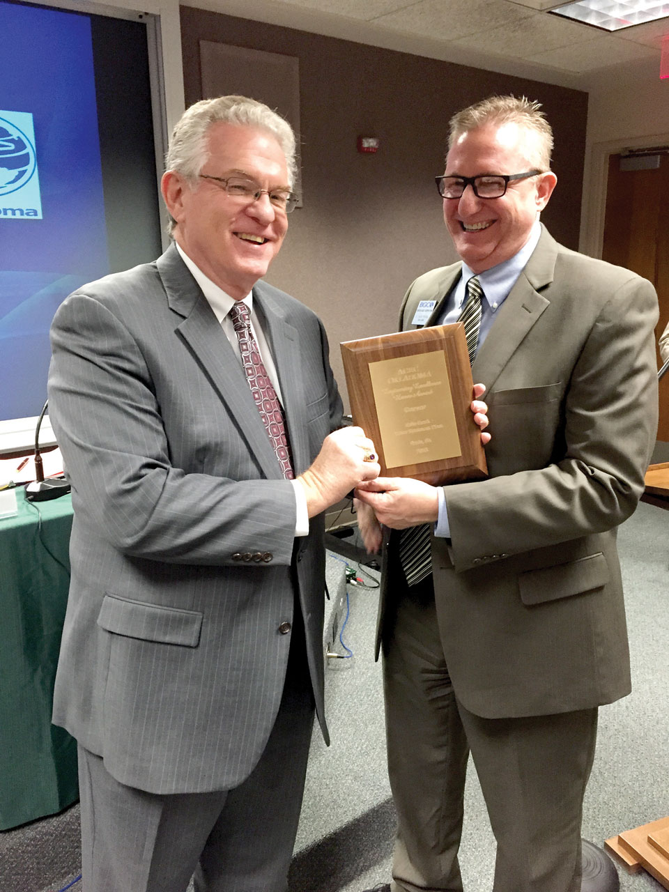 Anthony L. Jordan, BGCO executive director-treasurer, accepts an award from a national professional engineering society for excellence in design of the new Falls Creek wastewater treatment facility from Operations Team leader D. Scott Phillips, who has been overseeing Falls Creek construction and projects (Photo: Brian Hobbs)