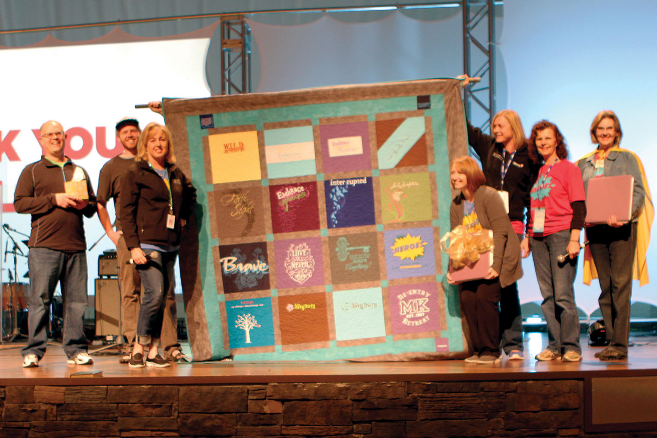 Kelly King, third from left, was honored for her 10 years of service, receiving a quilt made up of event T-shirts over the years (Photo: Tiffany Zylstra)