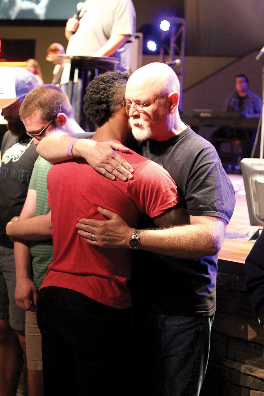 Mike Story, Director of the Oklahoma State University BCM, prays with a student (Photo: Tiffany Zylstra)