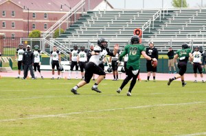 Linebacker Brynden Pizter (52) pressures quarterback Blake Woodard during the OBU Spring Game on April 11. The Green squad collected a 14-10 victory over the White squad. (Photo: Bill Pope)