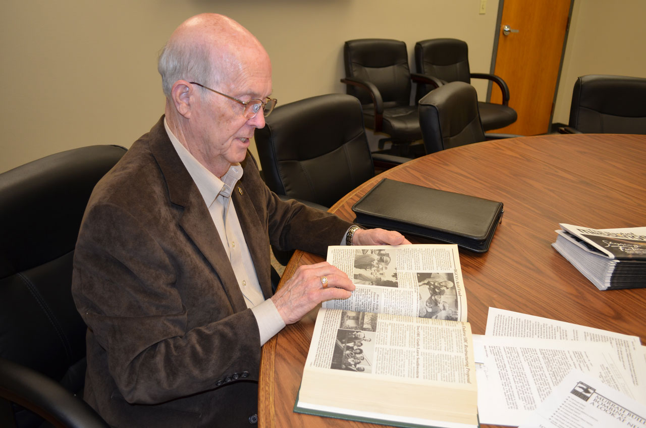 Williams looks through articles about the bombing in file copies of the Baptist Messenger from 1995 (Photo: Bob Nigh)