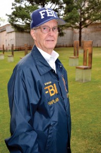 Williams in his FBI chaplain jacket and cap stands among the Field of Empty Chairs, which memorializes those who perished. (Photo: Bob Nigh)
