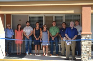 Preparing to cut the ribbon dedicating the Kannady Family Lodge, from left, are Gene Downing, Shiloh, Zac, Paige, Susan and Greg Kannady, Anthony L. Jordan, BGCO Equipping Team Leader and former Conference Centers Director James Swain and Dilbeck (Photo: Chris Doyle)