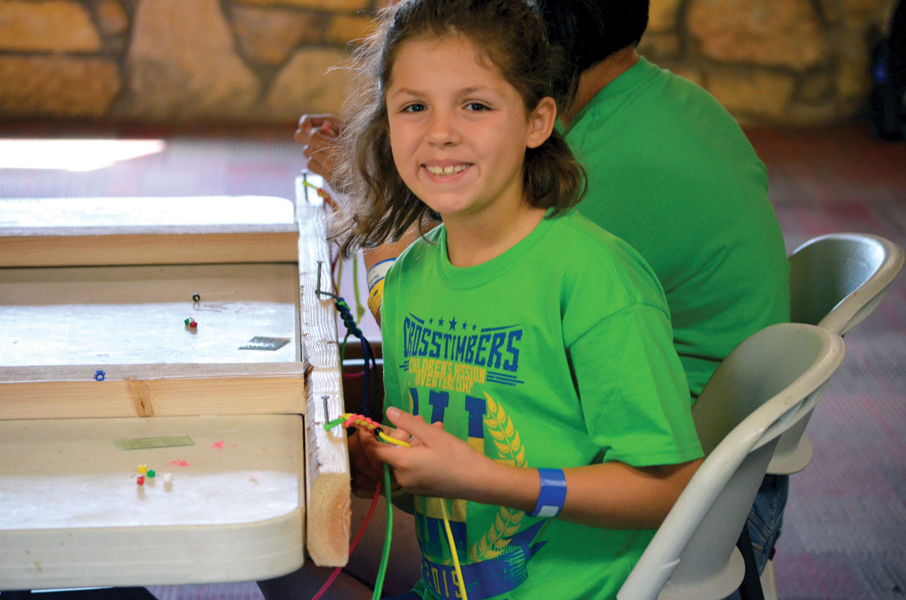2) A camper works on a bracelet that can be used to share the Gospel (Photo: Chris Doyle)