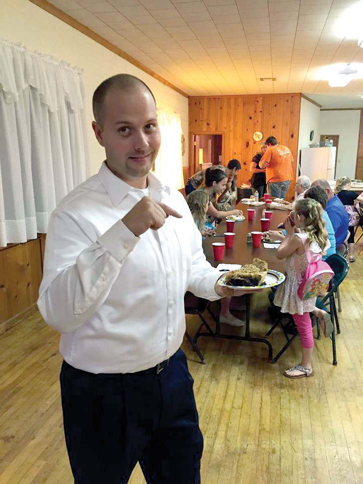 Johnny has a piece of pie at a fellowship at his church. (Photos: provided)