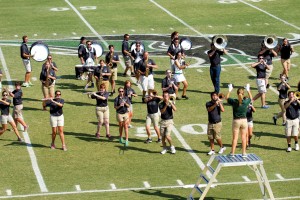 Drum Major Kathleen Houston, a junior elementary education major from Keller, Texas, leads the Bison Brigade from the podium in her second year as drum major. (Photo: Bill Pope)