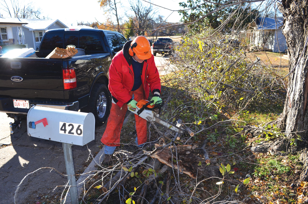 photo: Chris doyle A member of a Disaster Relief chain saw team helps in a Yukon neighborhood.