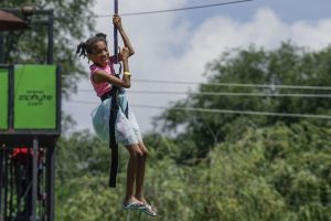Ten-year-old Jasmine rides a zip line at a block party hosted by Sterling Baptist Church in Fairview Heights, Ill. The block party was part of Crossover St. Louis 2016, held prior to the annual meeting of the Southern Baptist Convention June 14-15 at America's Center in St. Louis. (Photo: Matt Miller)