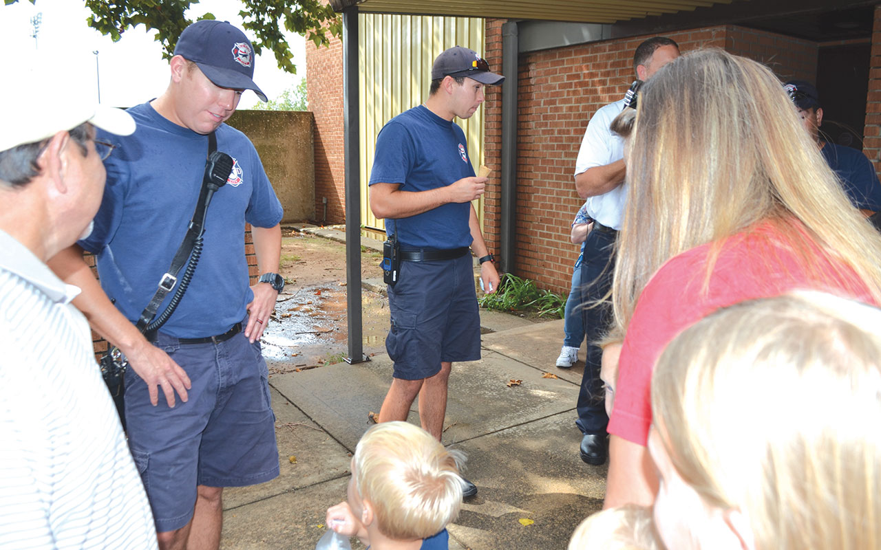 Midwest City firefighters visit with a young admirer and his family at the Aug. 25 ice cream social.