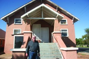 Carl Thionnet, director of missions for Concor-Kiowa Association, and interim pastor at Burns Flat, First, stands in front of the church building where he was baptized as an 8-year-old. The original structure was maintained as the church built on to it with a new worship center and educational space