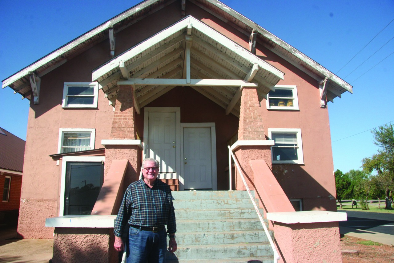 Carl Thionnet, director of missions for Concor-Kiowa Association, and interim pastor at Burns Flat, First, stands in front of the church building where he was baptized as an 8-year-old. The original structure was maintained as the church built on to it with a new worship center and educational space
