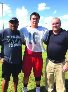 Dickey, also a pastor, rejoiced with Pastor Micky Miller, right, when team captian Trenton Palmer, center, made a profession of faith. Dickey was able to attend Palmer’s baptism at Grandfield, First. Photo: Provided