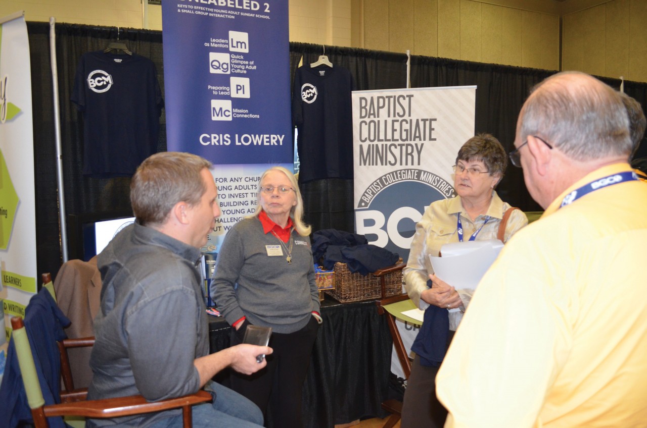 Chad Coleman, UCO BCM director, left, and Susanne Lillard, former BCM ministry assistant, second left, share about Baptist Collegiate Ministry at their booth during the 2015 BGCO Annual Meeting. 