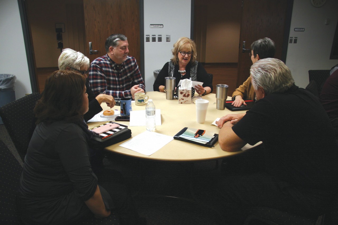  Cathy Price, BGCO Church Planting ministry assistant, center, reads her Legacy Letter to her table mates during an At-Home Day session at the Baptist Building